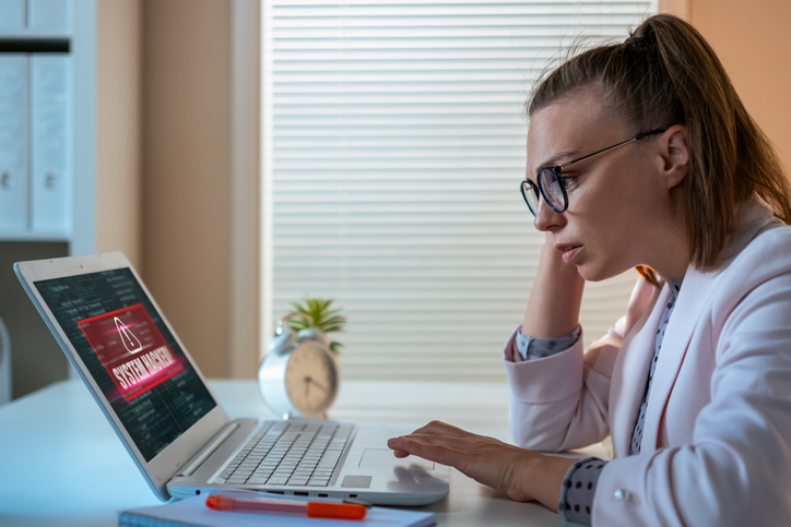 Worried woman looking at laptop