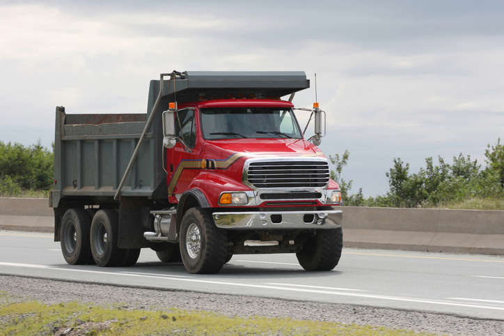 an image of a dump truck on a highway demonstrating the importance of dump truck insurance